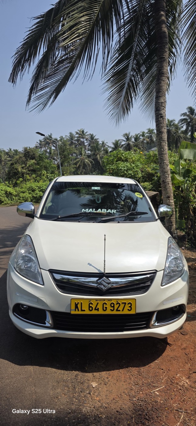 White Maruti Suzuki Dzire of Malabar Cabs in Kannur
